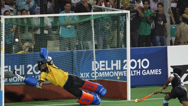 England's goalkeeper James Fair attempts unsuccesfully to stop the controversial penalty shot by Arjun Halappa of India.