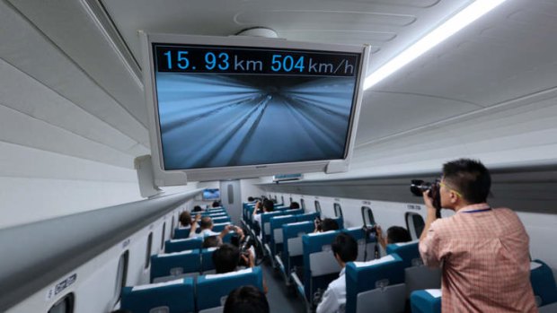 A monitor shows a live view from the front of the train and the current speed inside the magnetic-levitation train in Japan.