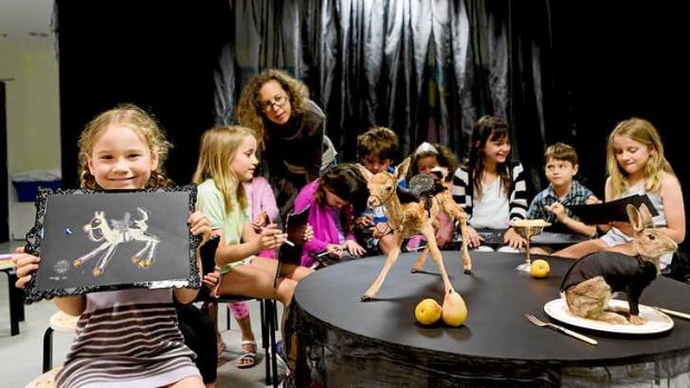 Saskia Romney (left) takes part in the children's drawing class led by artist Julia deVille (centre) at the NGV.