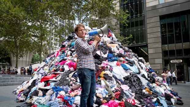 The Chaser's Craig Reucassel dumps six tonnes of 'fashion waste' in Sydney's Martin Place - to show the volume of clothes going to landfill in Australia every 10 minutes.