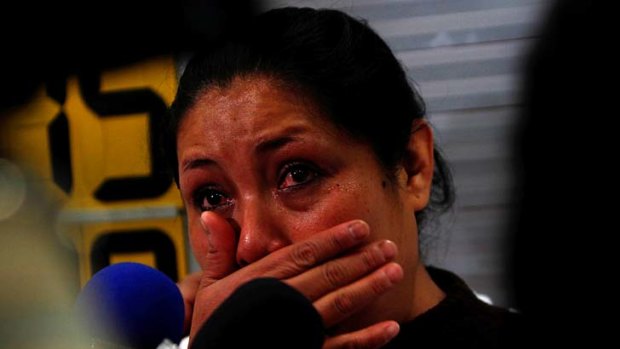 Overwhelmed ... Margarita Almaraz cries as she waits for her children to arrive in Mexico City.