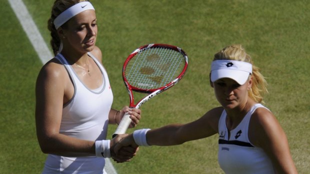 Agnieszka Radwanska, right  shakes the hand of Germany's Sabine Lisicki after Radwanska's defeat in their women's semi-final at Wimbledon.