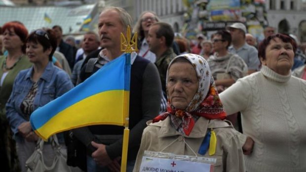 People gather during a rally in Independence Square in Kiev to mark Sunday's day of mourning after pro-Russia separatists shot down a Ukrainian military transport plane, killing all 49 crew and troops aboard.  