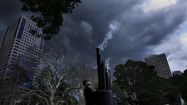 Grey skies, grey mood ... Walk Against Warming protesters in Belmore Park with a simulated wood-fired power station.