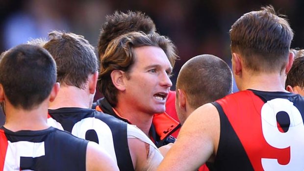 Bombers coach James Hird speaks to his players.
