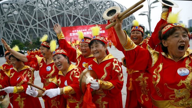 Performers in Beijing cheering ahead of the announcement of the winner city for the 2022 Winter Olympics bid.