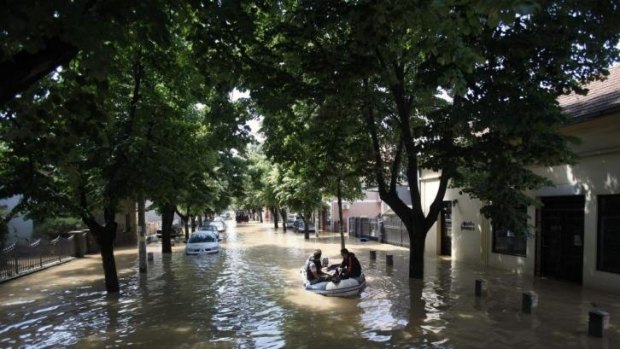 Residents escape on a boat in the flooded town of Obrenovac.