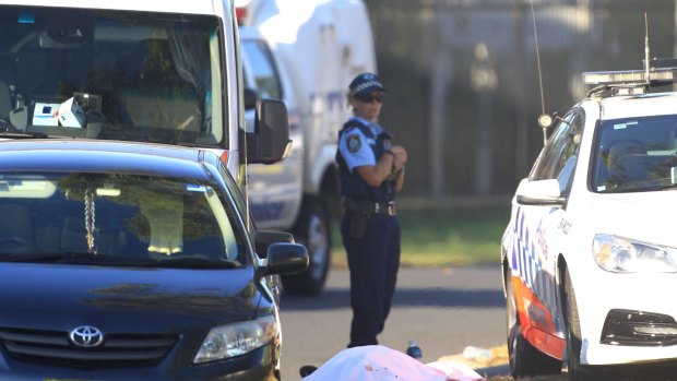 A police officer at the scene of the Ingleburn shooting, guarding what appeared to be a body.