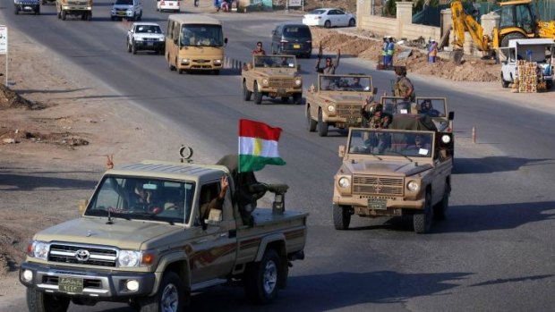 Iraqi Kurdish fighters drive through Erbil in northern Iraq on their way to the border with Turkey and ultimately the Syrian border town of Kobane.