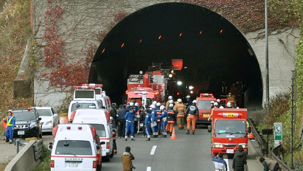 Police officers and firefighters gather at the exit of the collapsed Sasago Tunnel on the Chuo Expressway in Otsuki, Yamanashi Prefecture, in central Japan. Several people were feared trapped inside.