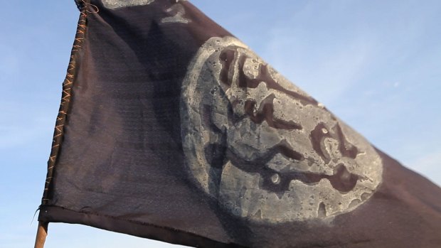 A Boko Haram flag flutters from an abandoned militant post in Gamboru on February 4, after Chadian troops retook the town in north-eastern Nigeria.