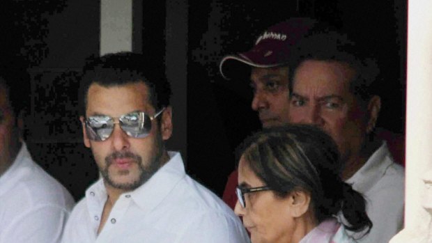 Salman Khan walks with his mother as he leaves home for court in Mumbai.