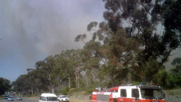 A fire rips through Kings Park as motorists are held up.