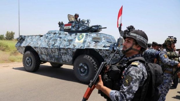 An Iraqi police patrol in Baghdad's Abu Ghraib suburb. Iraqi troops, backed by helicopter gunships, launched an operation on Saturday aimed at dislodging Sunni militants from the northern city of Tikrit.