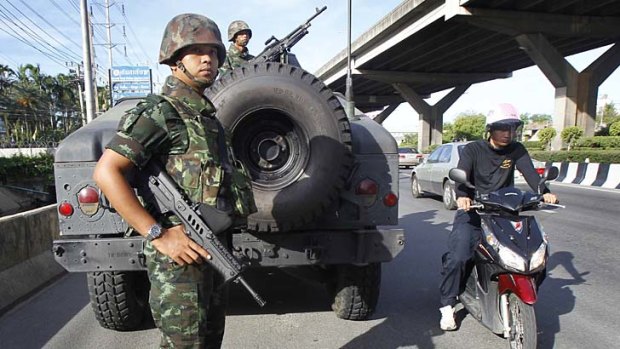 Thai soldiers take up a position on a main road in Bangkok after the army declared martial law on Tuesday.