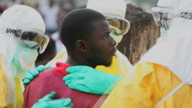 Health workers surround an Ebola patient who escaped from quarantine at Monrovia's Elwa hospital.