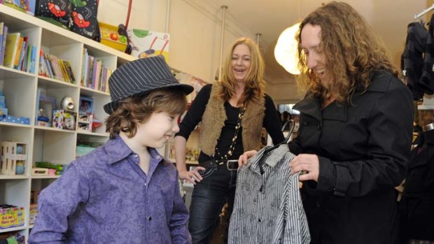 Height of fashion &#8230; Jo Tapp, right, helps her son Jaime Creswell, 7, choose a shirt at Hullubullu children's wear boutique with the assistance of Lisa Turner.