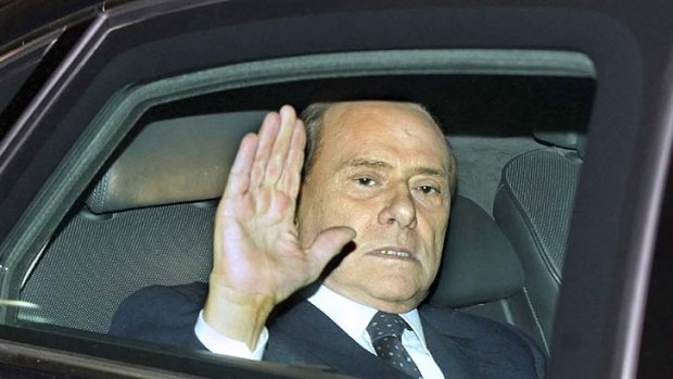 Silvio Berlusconi waves farewell after resigning as Italy's president, ending his colourful and controversial nine-year reign.