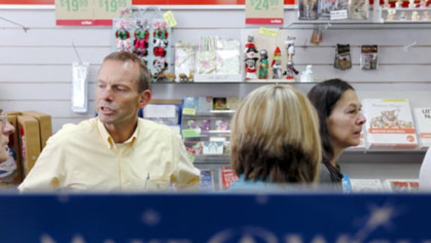 Listening and learning...Tony Abbott in a Hazelbrook shop yesterday. "Kevin Rudd is addicted to bureacracy."