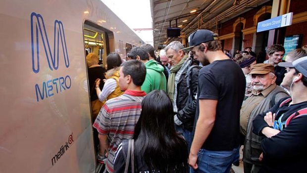Passengers squeeze onto a train at Flinders Street Station on Thursday.