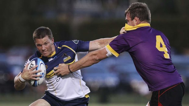 Clyde Rathbone is tackled by Gareth Clouston of the ACT XV, during the Super Rugby trial match on February 8.