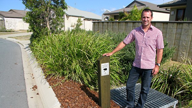 Storm water management expert Malcolm Eadie stands over a biopod at Bellvista Estate.