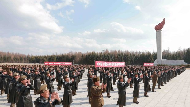 Korean People's Army pilots applaud North Korean leader Kim Jong Un in this undated photo released by North Korea's state-run news agency.