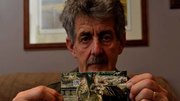 Tragedy ... Paul Twining with a photo of his late son David in East Timor with Brett Wood.