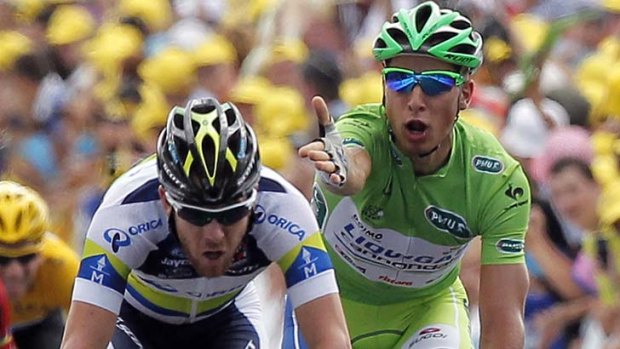 Unhappy ... Peter Sagan, right, gestures at Matthew Goss  on the finish line of the 12th stage of the Tour de France.