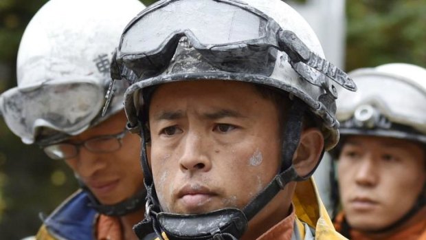 Rescuers arrive at Otaki, Nagano prefecture after being forced to descend Mount Ontake in central Japan due to rain.