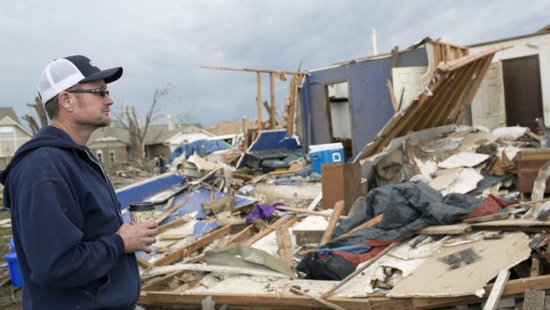 Mark Ellerd stands in front of his destroyed house on 4th Street in Moore, Oklahoma, May 21, 2013. As rescue workers continued on Tuesday to frantically search for survivors beneath mounds of debris, local residents like Ellerd came to grips with the destruction.