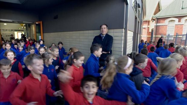 Port Melbourne Primary School principal Peter Martin, surrounded by his students.