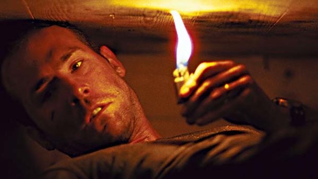 Six feet under ... Ryan Reynolds has only a lighter and mobile phone to escape his coffin.