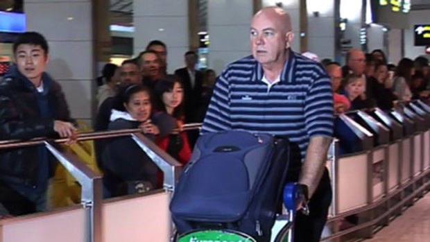 Australian umpire Steve Davis arrives in Melbourne this morning after narrowly surviving the Lahore terror attack.