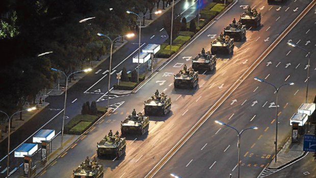 A line of armoured personnel carriers head towards Tiananmen Square for rehearsals for the 60th National Day in Beijing.