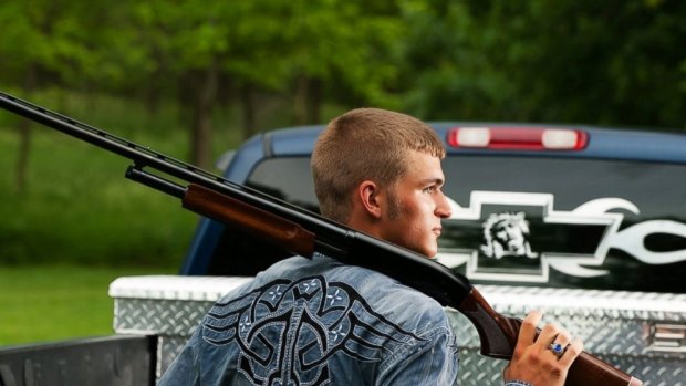 SCHOOL PORTRAIT: Dustin Langenberg of Bertrand, Nebraska, poses with a gun and a truck.