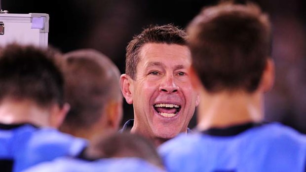 An animated Brett Ratten speaks to his players at three-quarter-time.