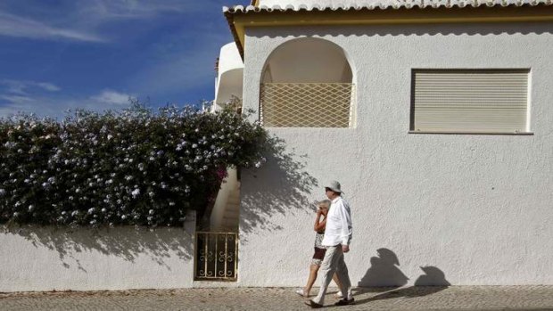 Crime scene: Tourists walk under the windows of the  apartment where Madeleine McCann disappeared.