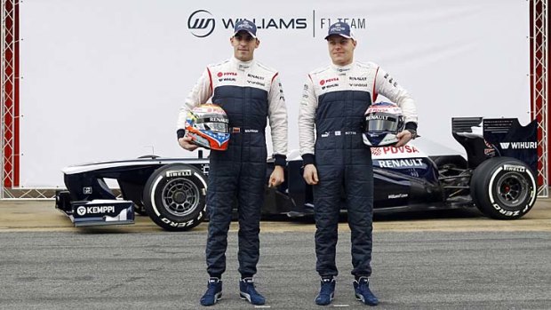 Williams Formula One drivers Pastor Maldonado and Valtteri Bottas pose with the new FW35 racing car.