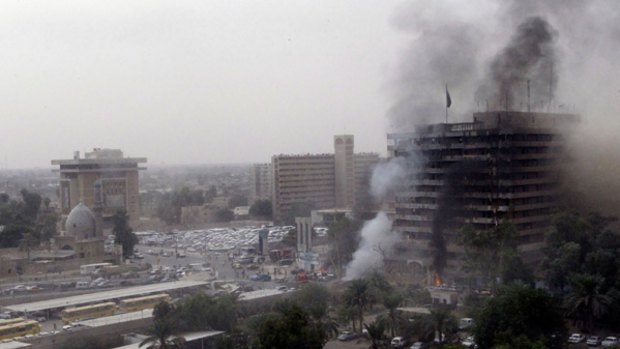 Scores dead .... smoke billows following a blast in central Baghdad.