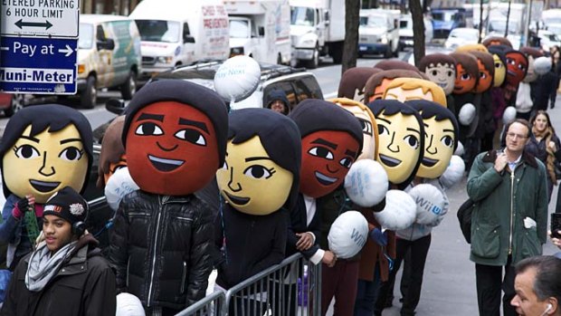 Nintendo Mii characters joining fans in line at Nintendo World for the launch of Wii U in New York.
