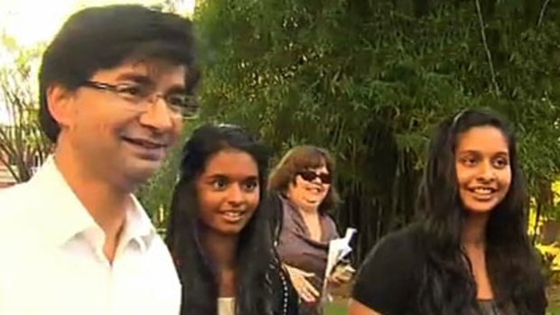 A smiling Lloyd Rayney is reunited with his daughters Caitlyn (centre) and Sarah (right).