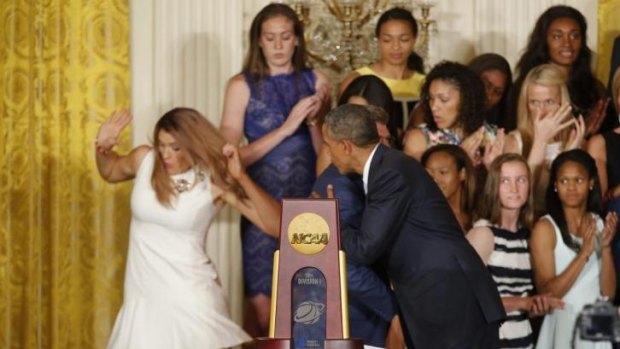 UConn women's basketball star Stefanie Dolson slips on the stage when meeting President Barack Obama.