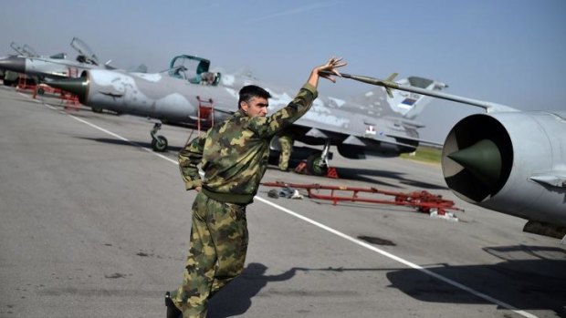 An aircraft mechanic holds the Pitot tube of a Serbian Air Force MiG 21 at the Batajnica military airport near Belgrade. Islamic State pilots are reportedly training in MiG 21 and 23 models.