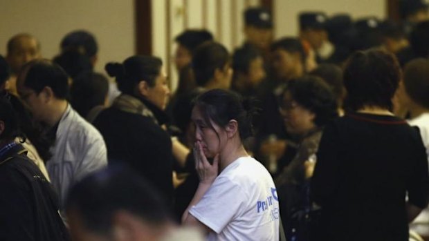 A relative of a passenger aboard Malaysia Airlines MH370 reacts as she leaves a room after a briefing by the Malaysian government, at the Lido Hotel in Beijing. 