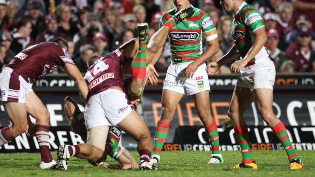Rough treatment: Greg Inglis lands heavily after a dangerous tackle by Richie Fa'aoso at Brookvale in round seven.