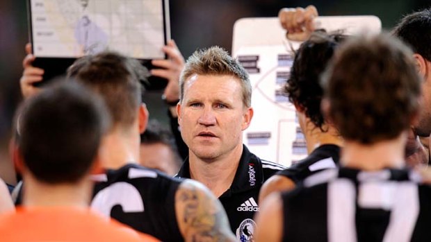 Collingwood coach Nathan Buckley addresses his players during a break this year.