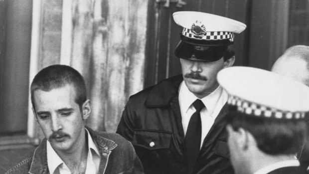 Julian Knight, left, being taken away by police after the Hoddle Street shooting. 