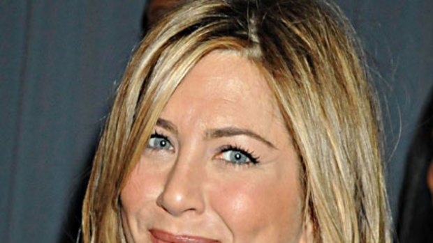 Fun in the sun ... Jennifer Aniston gets an early birthday present from Gerard Butler.