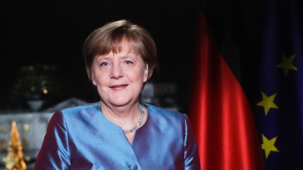 German Chancellor Angela Merkel poses for photographs after the television recording of her annual New Year's speech.